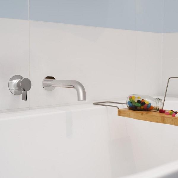 Clark round chrome basin/bath outlet with 180mm reach, wall-mounted over a white bath with mixer and tray