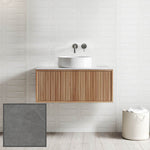 Ingrain Grooved wall-hung vanity with fluted woodgrain front, white basin and grey porcelain top in bathroom setting