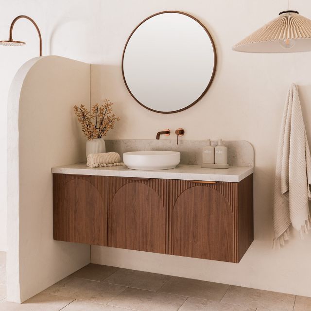 ADP Archie wall hung vanity with Caesarstone top, woodgrain finish, arched fronts and round basin in a bathroom setting