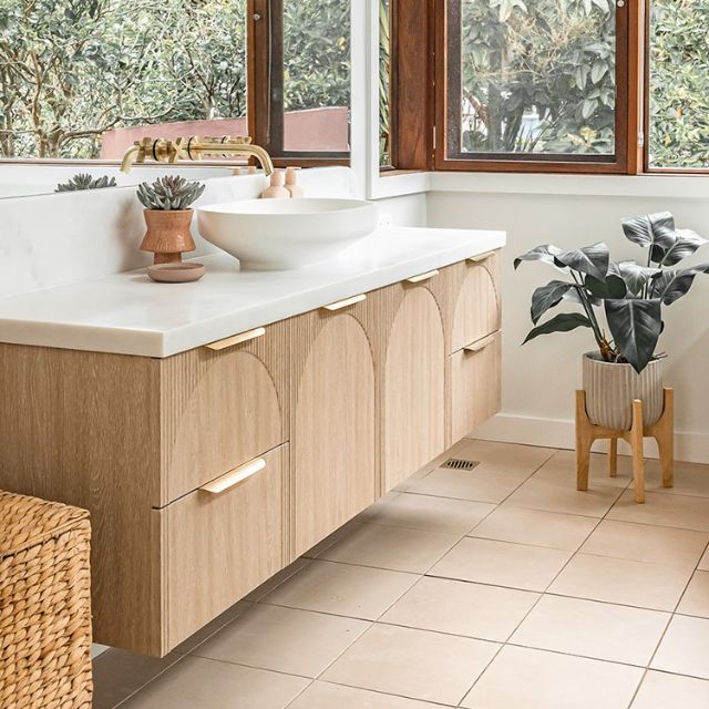 ADP Archie wall hung vanity in light timber finish with white top and curved front detail, shown in a bathroom setting