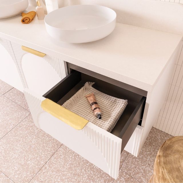 ADP Archie wall hung vanity in white with Caesarstone top, arched panel detail and open drawer in bathroom setting