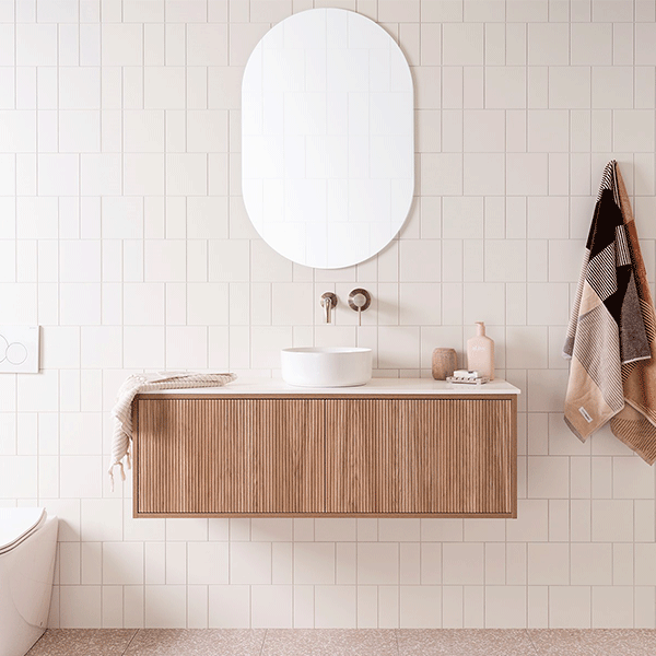 ADP Clifton wall-hung ensuite vanity in Prime Oak with white Durasein top, round basin and ribbed front, bathroom setting