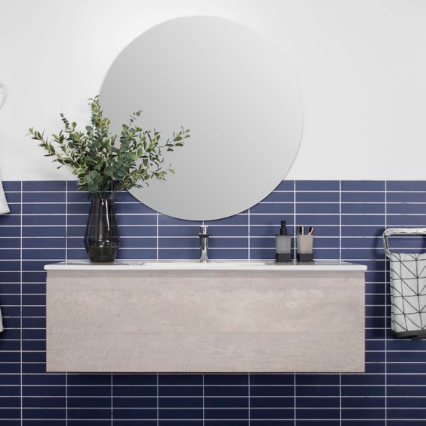 Wall hung ADP Glacier Lite slim vanity with ceramic top in light concrete finish and round mirror, front view