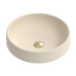 ADP Jean round above counter basin in Butter concrete, with a non-overflow bowl and gold waste cap