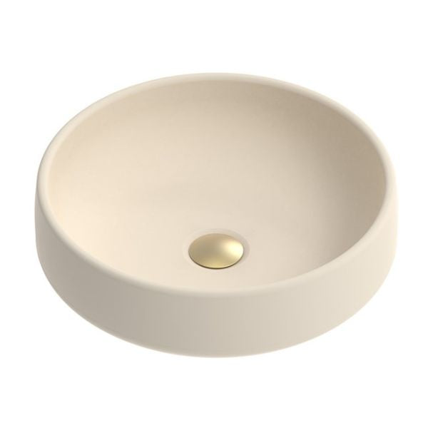 ADP Jean round above counter basin in Butter concrete, with a non-overflow bowl and gold waste cap