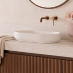 ADP Marilyn gloss white oval above counter basin on a beige vanity with bronze tapware