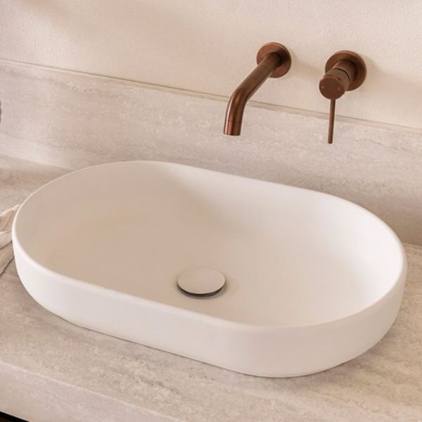 ADP Marilyn matte white oval above counter basin on a stone vanity with wall-mounted tapware