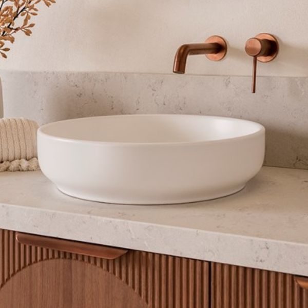 ADP Monroe matte white round above counter basin on stone vanity with copper wall tapware