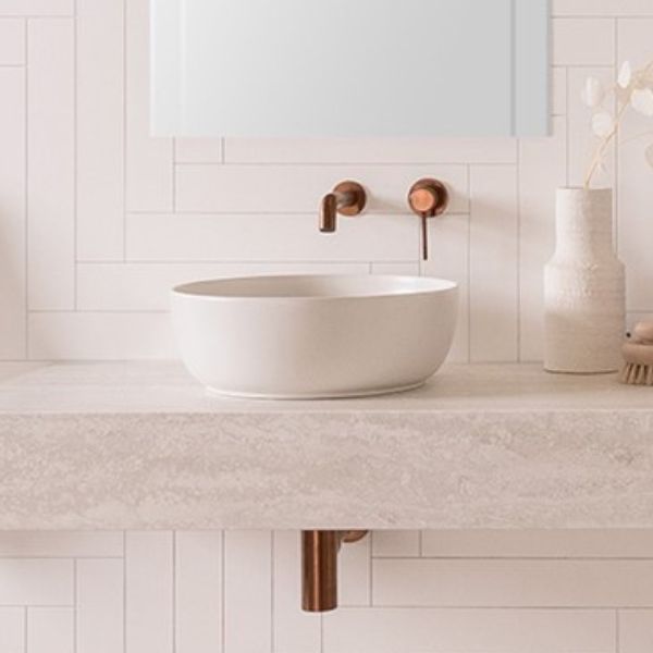 ADP Scarabeo Glam round above counter basin in matte pearl white on a bathroom vanity with wall mixer taps