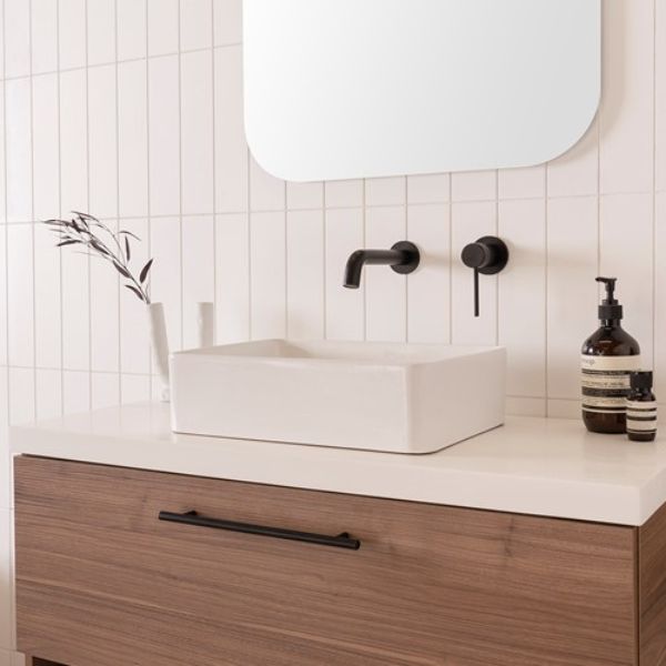 ADP Selma white rectangular above-counter basin on a vanity with wall-mounted black tapware