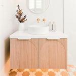 ADP Archie wall hung vanity with white benchtop, arched timber doors and round basin in a bright bathroom