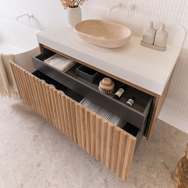 ADP Harper wall hung vanity with Caesarstone top, oak woodgrain drawers and white bench in bathroom setting