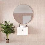 Marquis Anna wall-hung ensuite vanity in white, with round basin and black tapware, styled against pink tiled wall