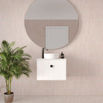 Marquis Anna wall-hung ensuite vanity in white, with above-counter basin, black tapware and round mirror in a tiled bathroom setting