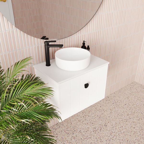Marquis Anna wall hung ensuite vanity in white with round above-counter basin and black tapware, styled in a bathroom setting