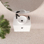 Marquis Anna wall-hung ensuite vanity in matte white, with round above-counter basin, black mixer and handles in a bathroom setting