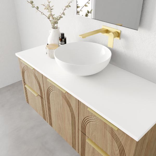Marquis Arco wall hung vanity with white top, oak arch-front drawers and brushed brass handles, shown in a bathroom