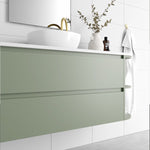 Marquis Avion wall hung vanity in sage green with white top, round basin and curved right-side shelf in bathroom setting