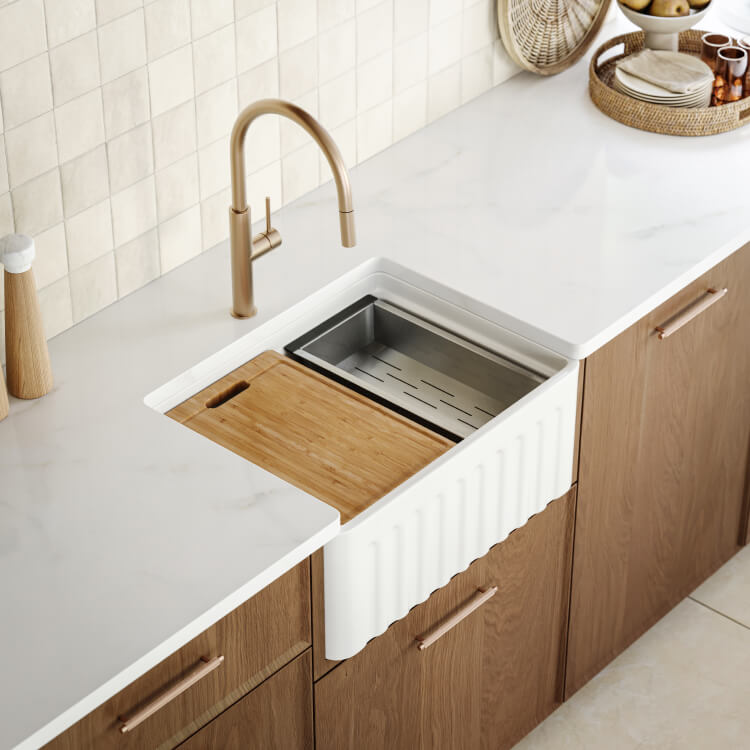 Bao Bath gloss white ceramic farmhouse sink with timber chopping board and colander in a kitchen benchtop viewed from above