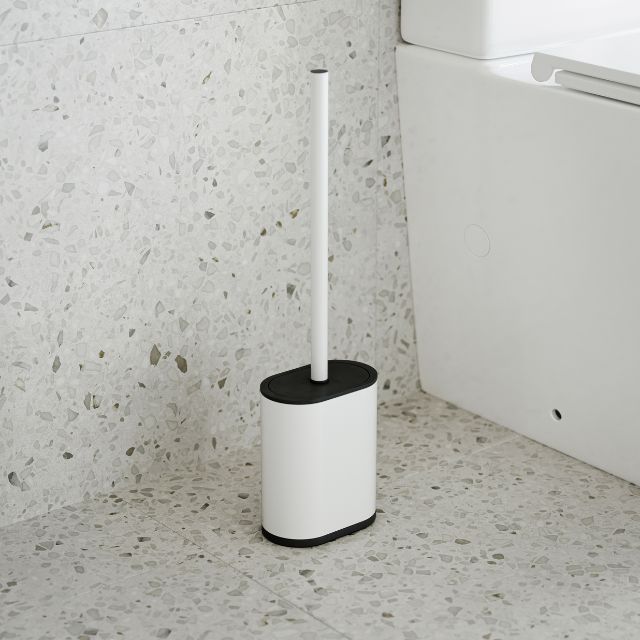 Bao Bath matte white silicone toilet brush with black holder beside a toilet in a bathroom