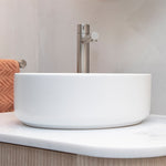 Phoenix Vivid Slimline vessel mixer in brushed nickel above a white vessel basin, bathroom setting