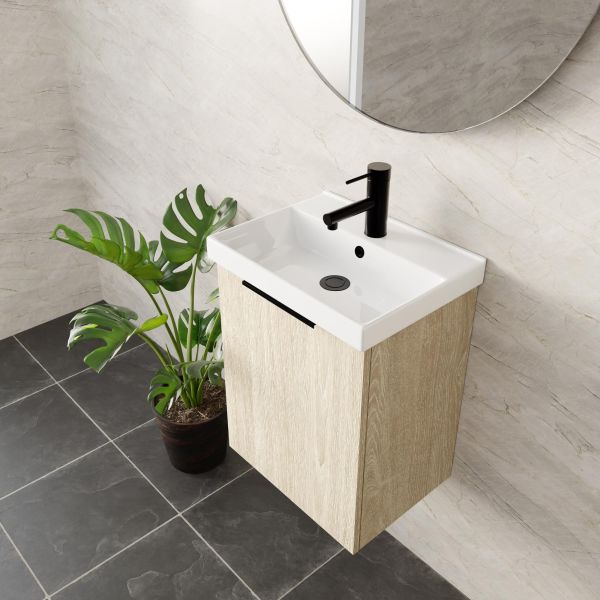 Marquis Caleta compact wall hung vanity in coastal oak with white ceramic top and black handle in bathroom setting