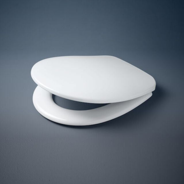 Caroma Profile white toilet seat with soft close hinges, closed on dark background