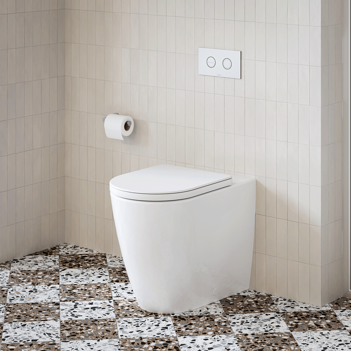 Caroma wall-faced white toilet suite with in-wall cistern and dual flush button on tiled bathroom floor