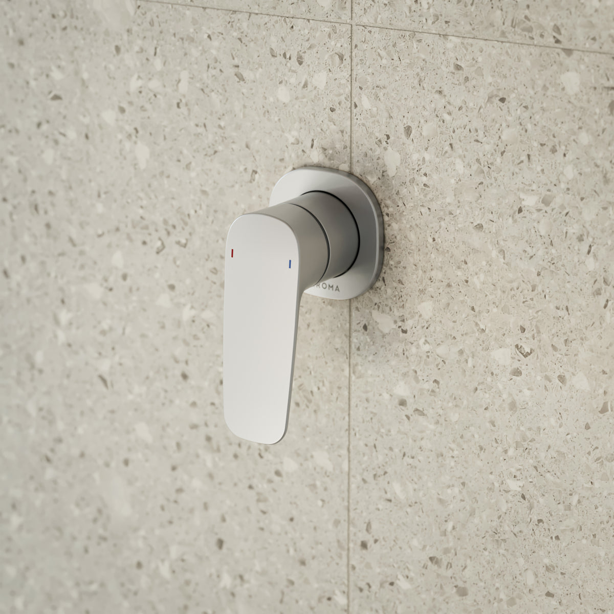 Caroma Contura II wall-mounted bath/shower mixer in brushed nickel on speckled stone tile wall