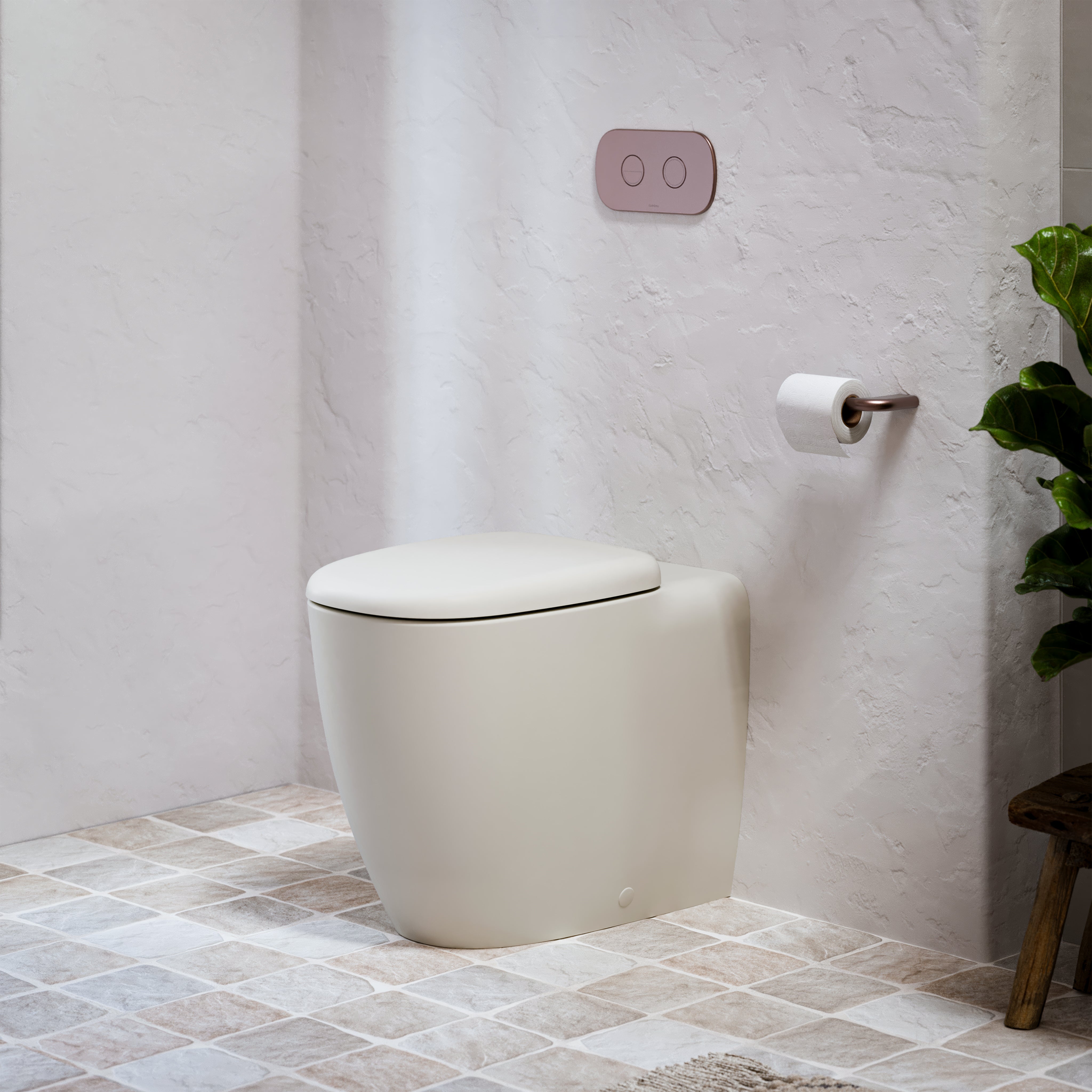 Caroma Contura II wall-faced toilet suite in clay/beige, with concealed cistern, soft-close seat and flush plate in a styled bathroom