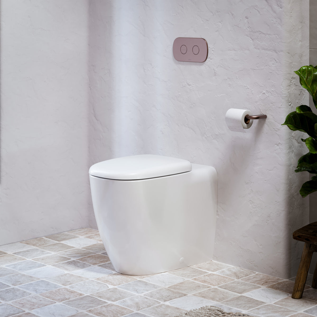 Caroma white wall-faced toilet suite with concealed cistern, flush plate and soft close seat in a tiled bathroom setting