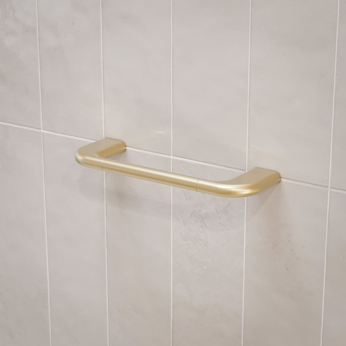 Caroma Contura II brushed brass hand towel rail mounted on light tiled wall