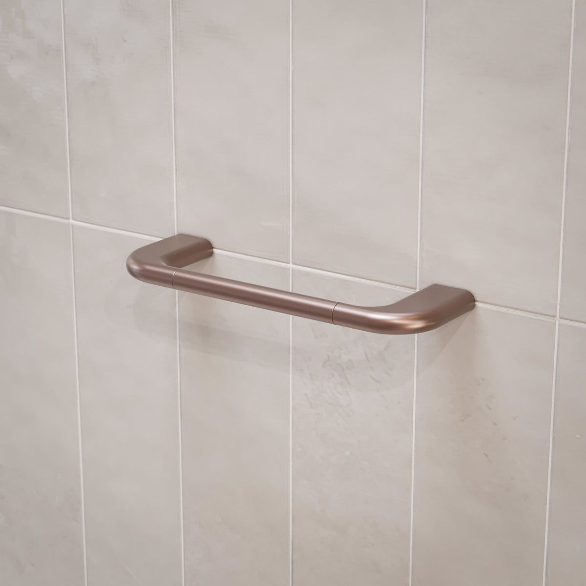 Caroma Contura II hand towel rail in brushed bronze on tiled bathroom wall