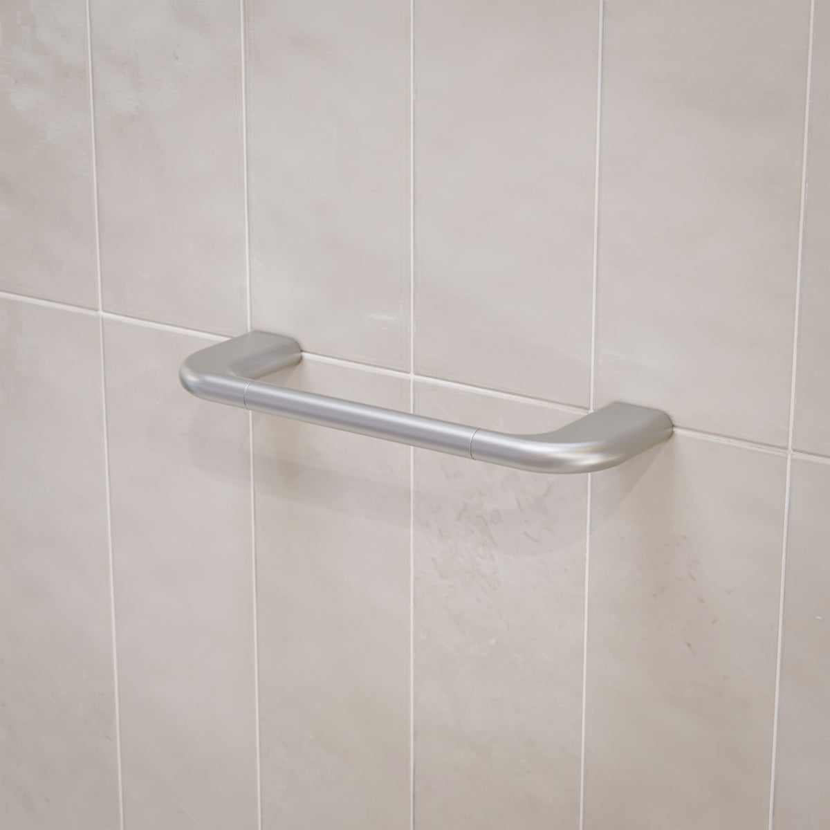 Caroma Contura II brushed nickel hand towel rail mounted on light tiled bathroom wall