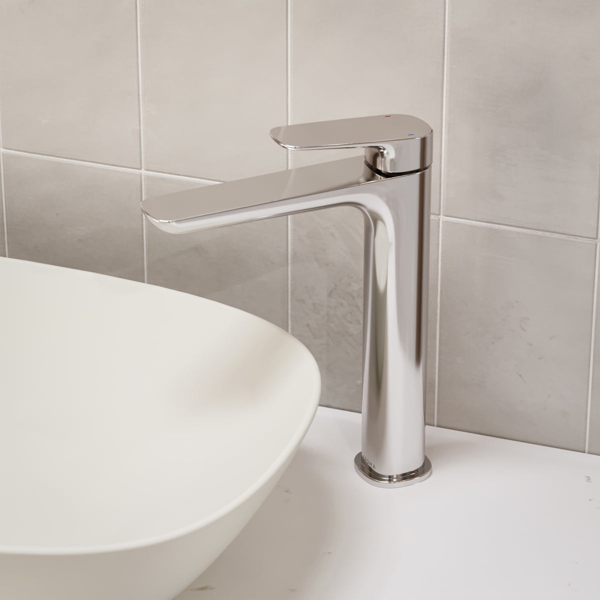 Caroma Contura II tower basin mixer in chrome, shown hob mounted beside a white above-counter basin.