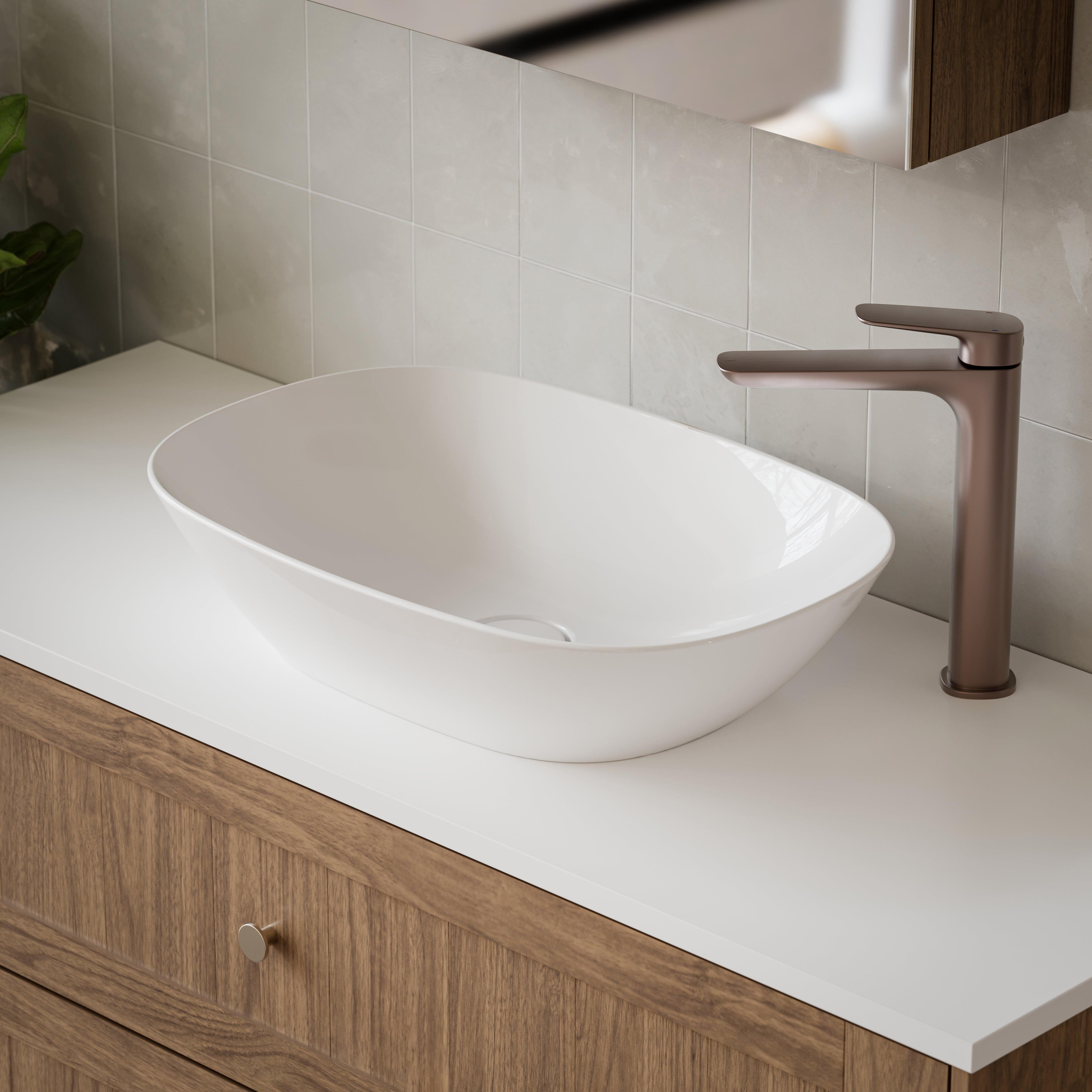 Caroma Contura II white oval above-counter ceramic basin on a bathroom vanity, with matte bronze mixer tap