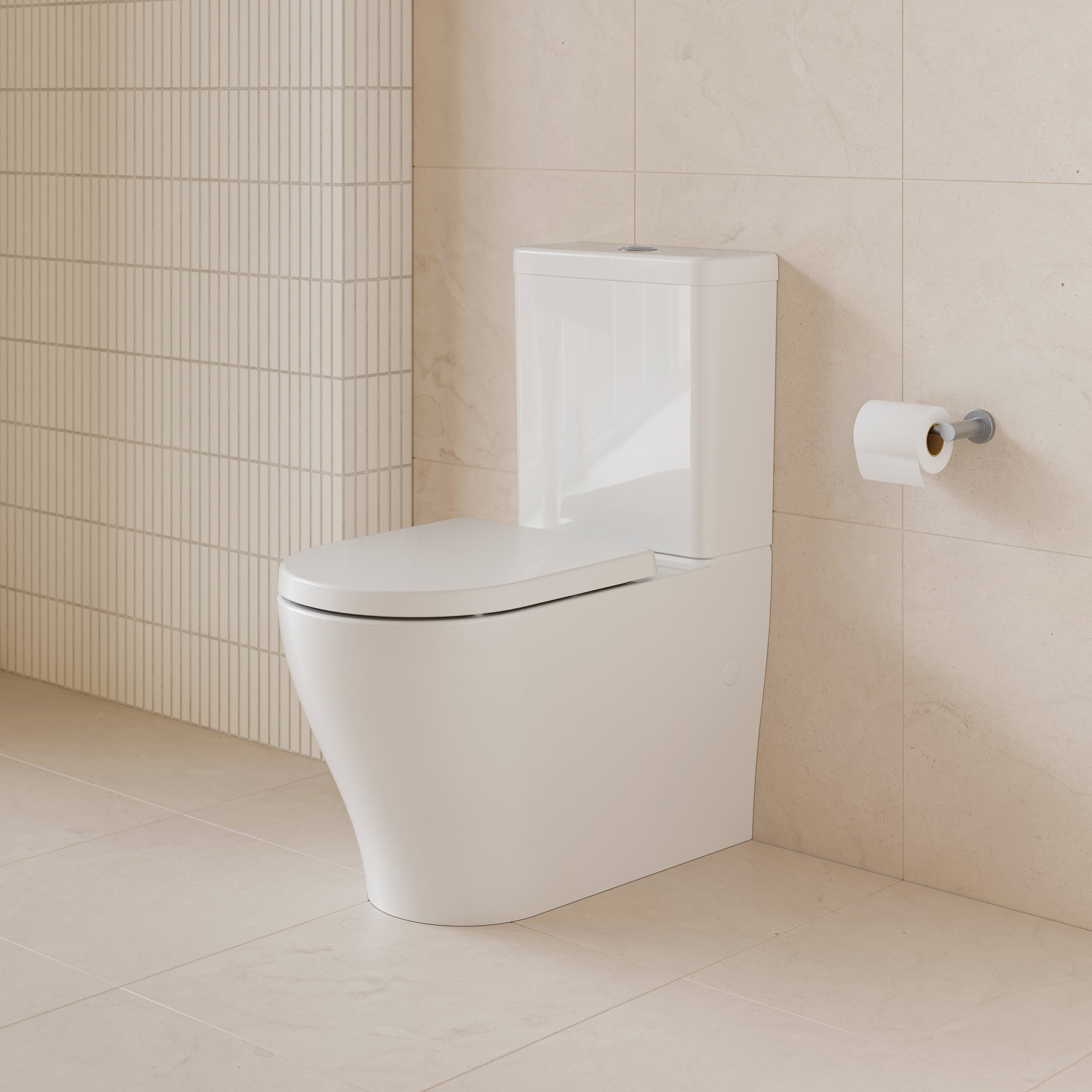 Caroma Luna Slim white wall faced toilet suite in a modern bathroom, front view with slim cistern and closed seat