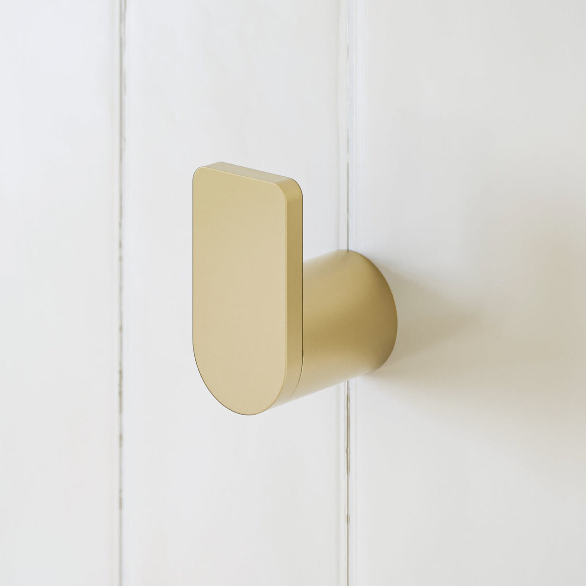 Caroma Urbane II brushed brass robe hook on white wall, shown in close-up side view