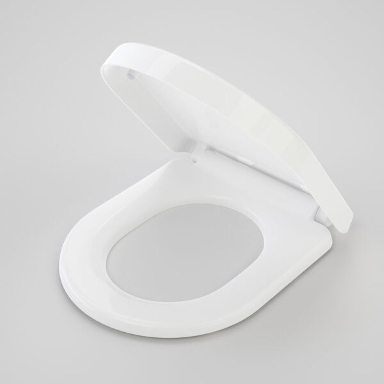 Caroma Urbane Compact white soft close toilet seat with lid, shown open on a light grey background