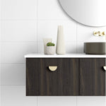 Marquis Chifley wall hung vanity in dark woodgrain finish with white benchtop, half visible in bathroom setting