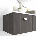 Marquis Chifley wall hung vanity in dark woodgrain with white top, shown in bathroom with brass handle and basin partially visible