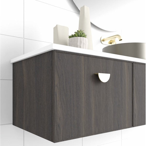 Marquis Chifley wall hung vanity in dark woodgrain with white top, shown in bathroom with brass handle and basin partially visible
