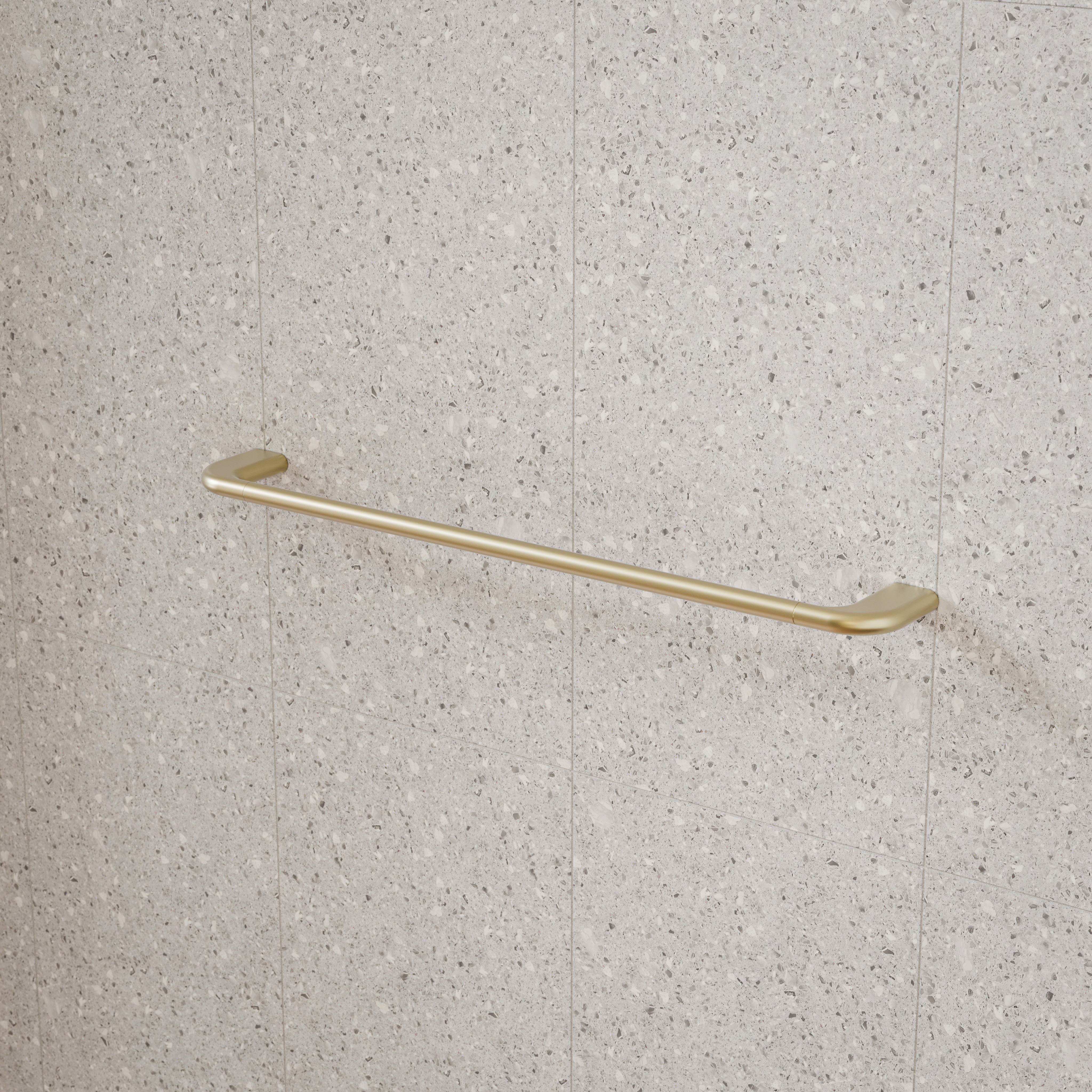 Caroma Contura II single towel rail in brushed brass, wall mounted on speckled stone-look tiles