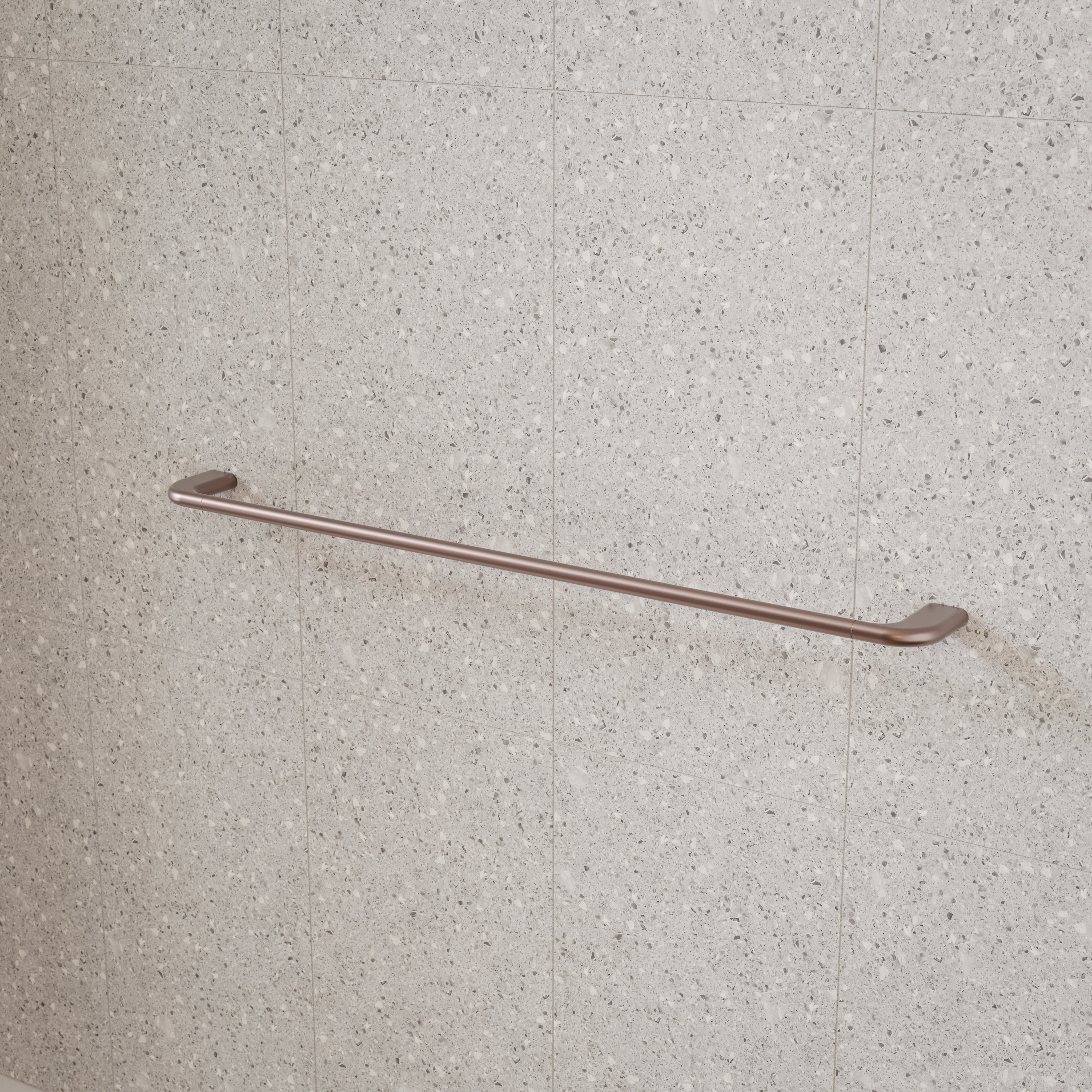 Caroma Contura II brushed bronze single towel rail on light grey bathroom tiles, wall-mounted horizontal view