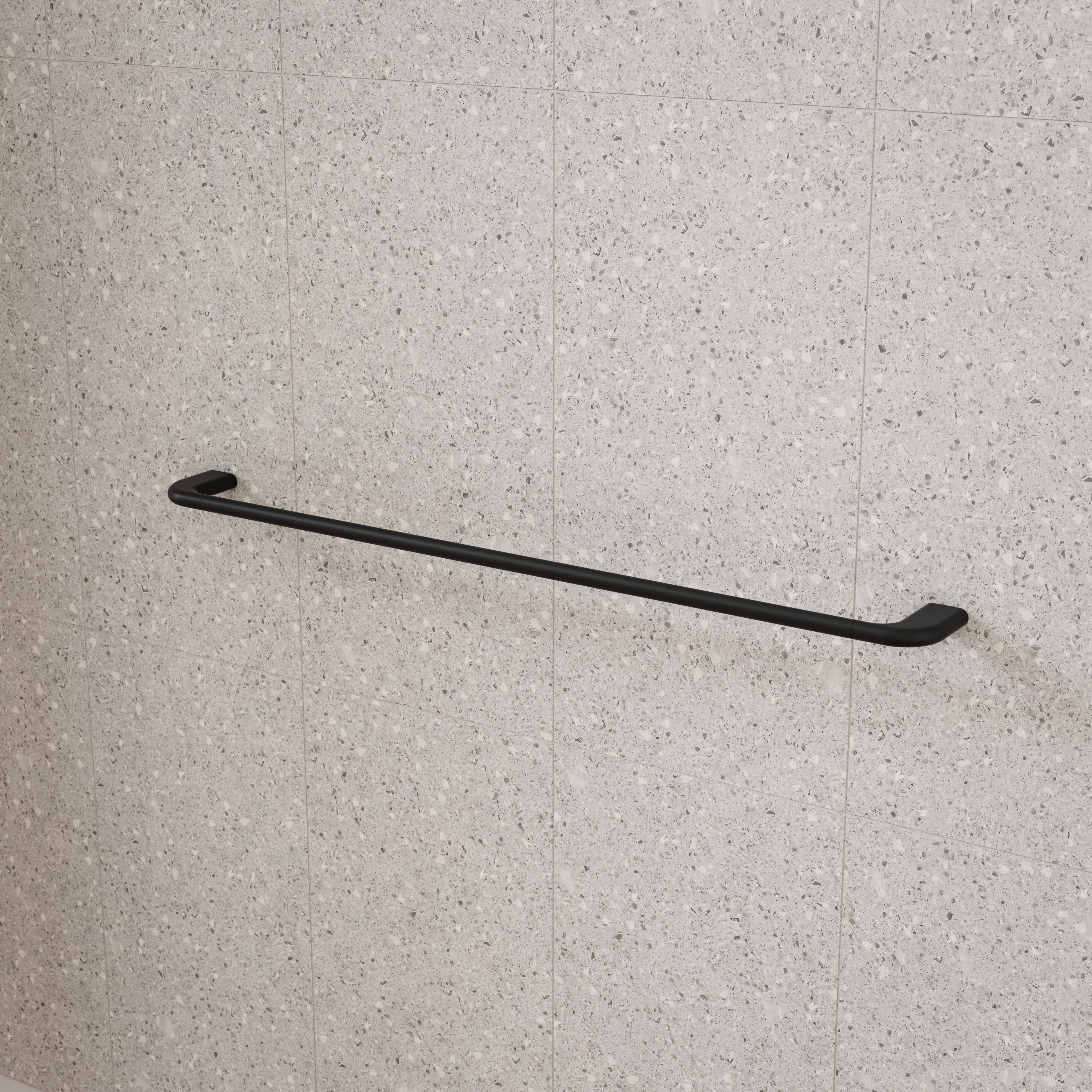 Caroma Contura II matte black single towel rail on a tiled bathroom wall, shown in a simple lifestyle view