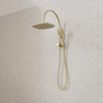 Caroma Contura II compact twin shower in brushed brass, with overhead shower and adjustable hand shower on rail