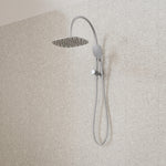 Caroma Contura II twin shower in brushed nickel, with round overhead shower and hand shower on wall rail
