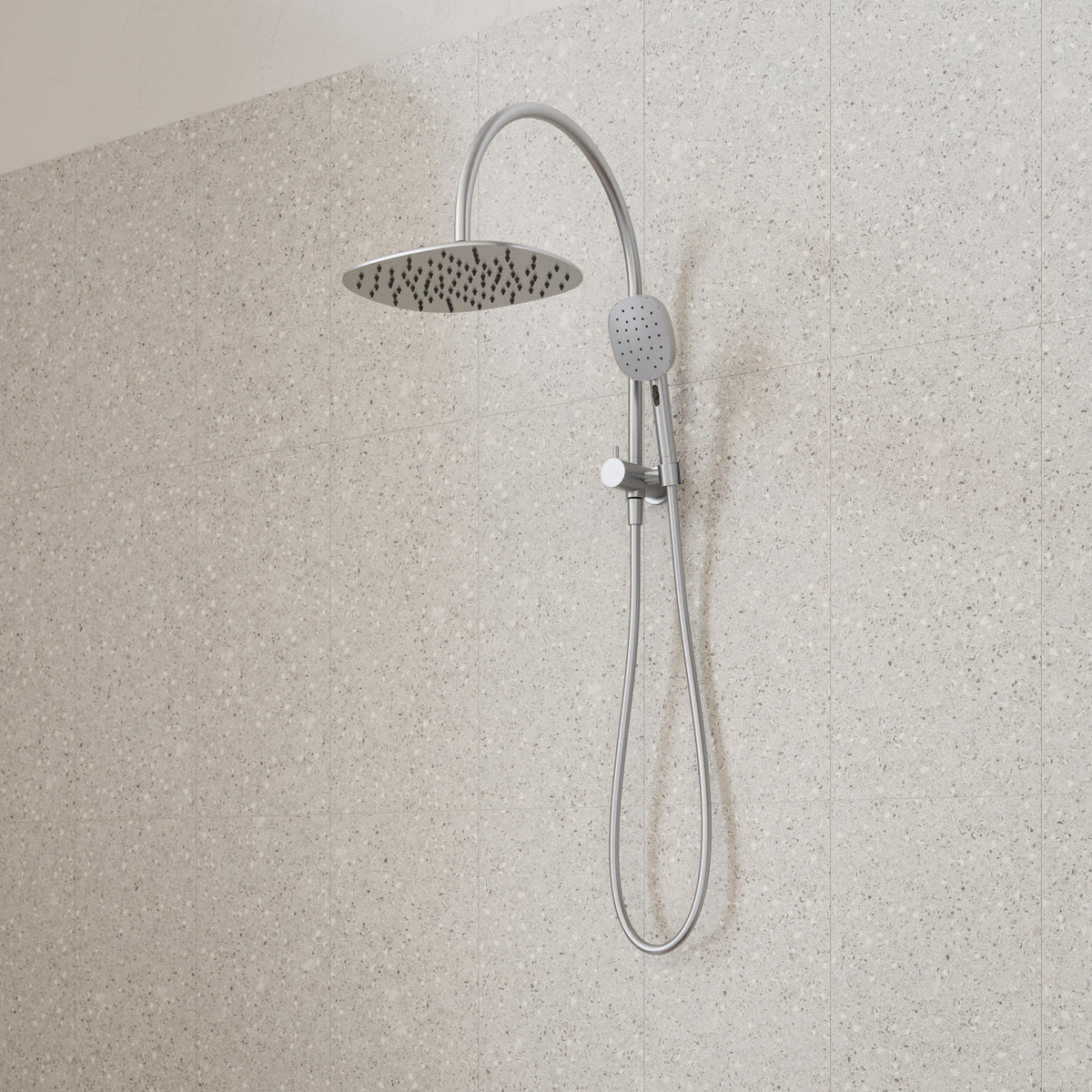 Caroma Contura II twin shower in brushed nickel, with round overhead shower and hand shower on wall rail