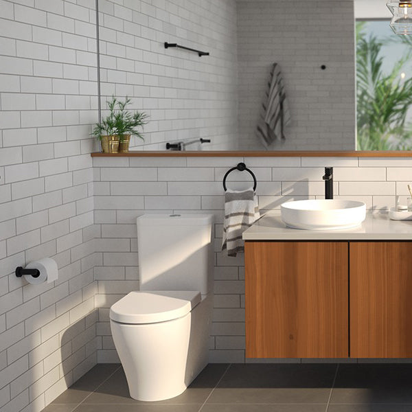 Caroma Cosmo matte black metal towel ring holding a hand towel beside a bathroom vanity and basin