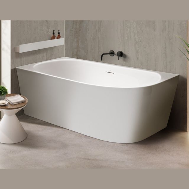 Decina Natalia white back-to-wall corner bath, oval freestanding style, shown in a modern bathroom corner view